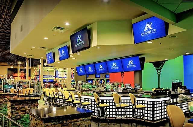 bar area with screens and seating at andretti indoor karting games orlando