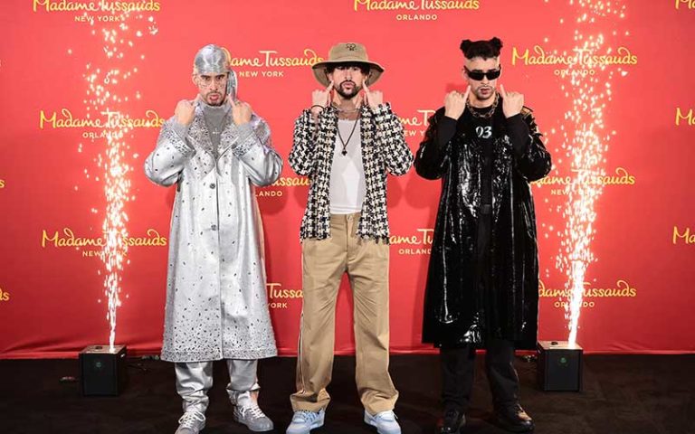 celebrities bad bunny standing beside wax replica figures at madame tussauds orlando at icon park