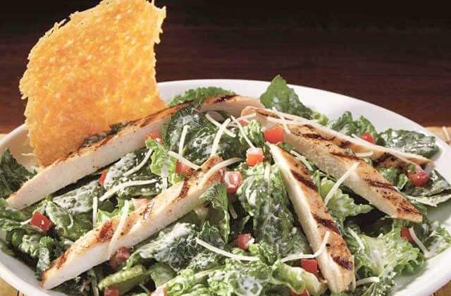 chicken caesar salad in large bowl at dave and busters orlando