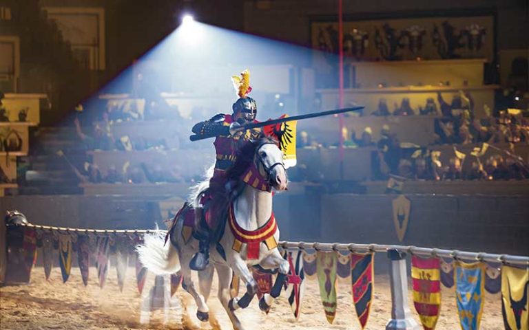 colorful knight on horseback running for joust at medieval times dinner and tournament orlando