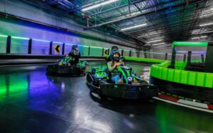 couple in go karts racing around track at andretti indoor karting games orlando