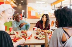 diners laughing and talking while eating pizza at cicis pizza orlando florida