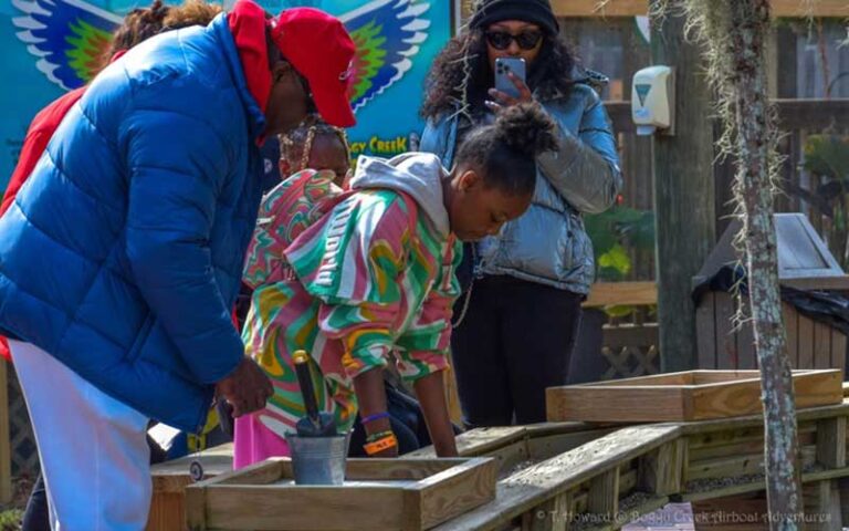 family interacting with gem mine at boggy creek airboat adventures kissimmee