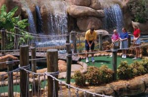family of four putting near waterfall congo river golf orlando kissimmee