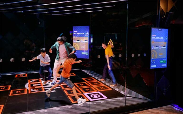 family playing interactive lighted floor game at dave busters orlando
