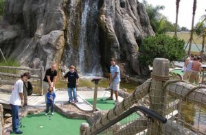 family putts with waterfall in the background at bonanza golf gifts kissimmee