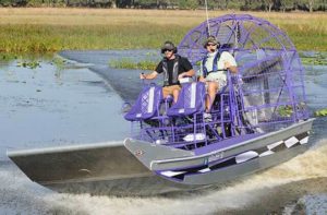 fanboat speeds across wetlands at boggy creek airboat adventures kissimmee