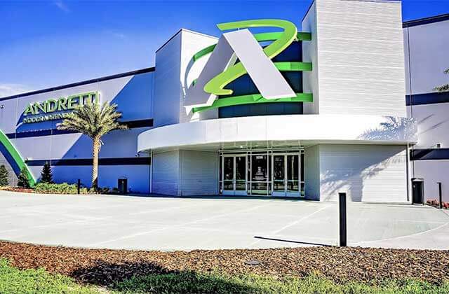 front exterior of building with signs at andretti indoor karting games orlando
