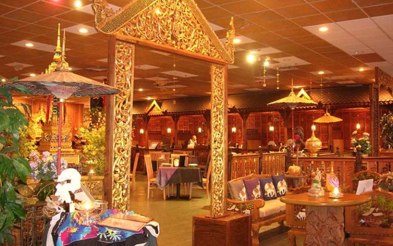gateway arbor brass inside restaurant with tables and thai decor at thai thani