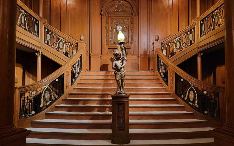 grand staircase with wood angel at titanic the artifact exhibition orlando