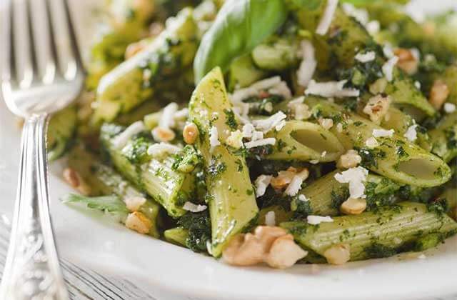 green penne pasta dish with plate fork oreganatta italian buffet orlando