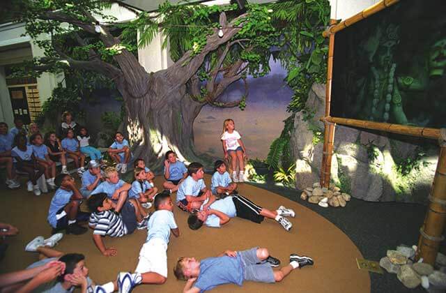 group of kids seated on the floor watching animated program on screen at jesus film project orlando