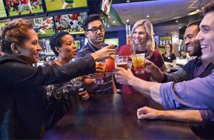 group toasting drinks in bar area dave and busters orlando