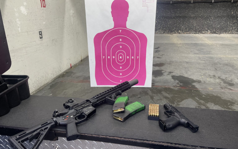 gun range with pink target automatic weapon handgun and ammo at shooting gallery range orlando