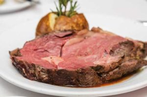 juicy steak with baked potato entree at black angus steakhouse florida