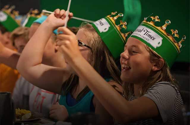 kids with green crown hats cheering medieval times dinner tournament kissimmee