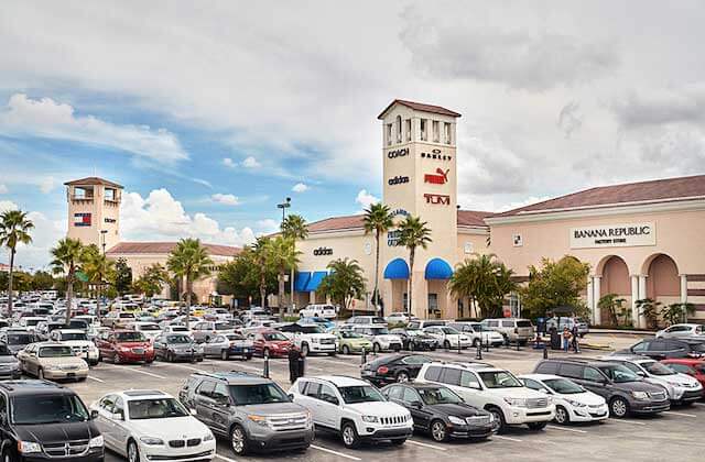 large parking lot with cars with exterior shopping center at orlando vineland premium outlets