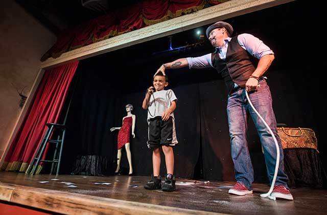 magician with kids on stage outta control magic comedy dinner show orlando