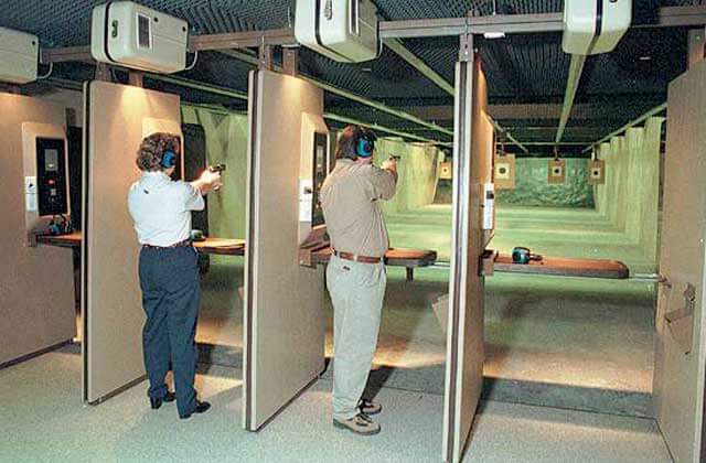 man and woman firing handguns indoor range shooting gallery range orlando