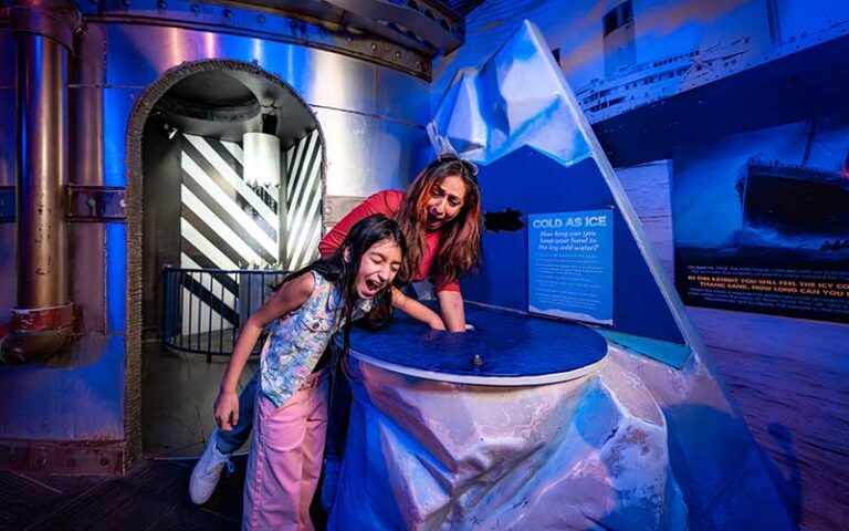 mom and daughter screaming while interacting with science exhibit at wonderworks orlando