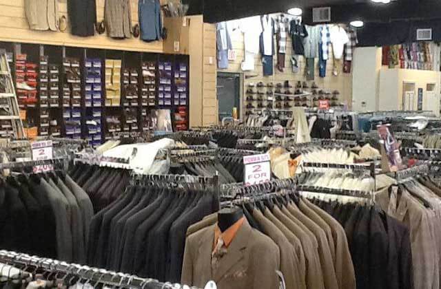 multiple racks of mens suits and formal attire at orlandos gk menswear store