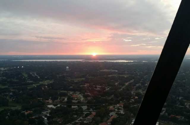 orange sunset over landscape at maxflight helicopter tour services kissimmee