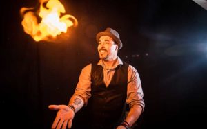 performer magician creates fireball on stage at outta control magic comedy dinner show wonderworks orlando