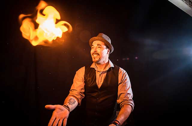 performer making flame poof outta control magic comedy dinner show orlando