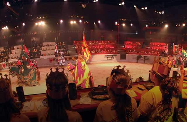 row of diners seated in arena watching knights medieval times dinner tournament kissimmee