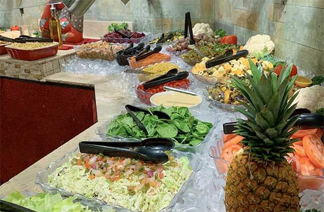 salad and fruit bar on ice at cafe mineiro brazilian steakhouse orlando