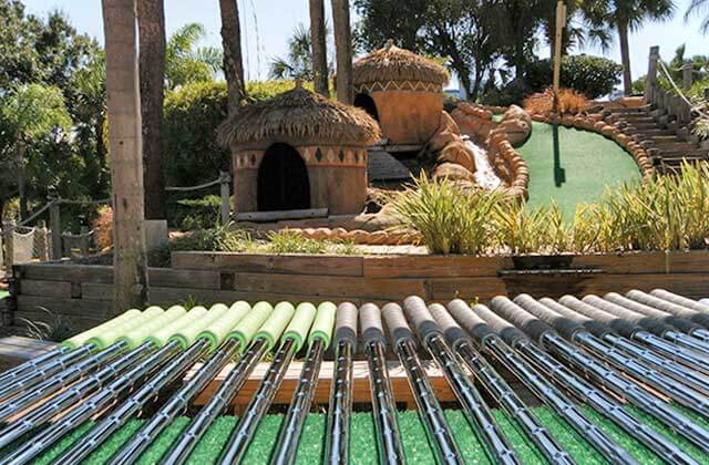 selection of putters with course background lost caverns adventure golf orlando