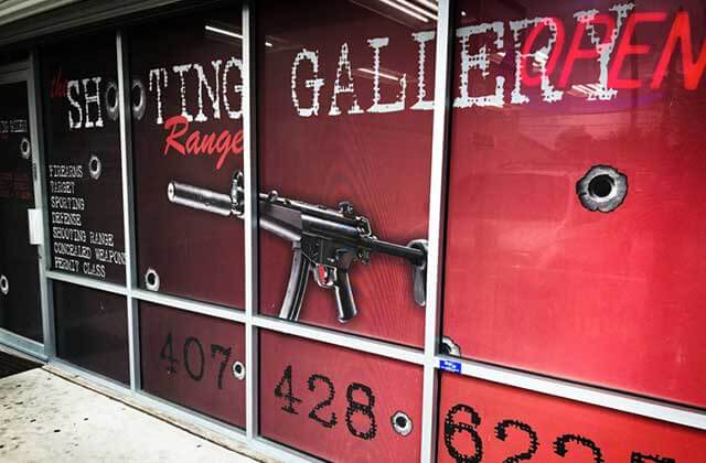 store front window with machine gun sign shooting gallery range orlando