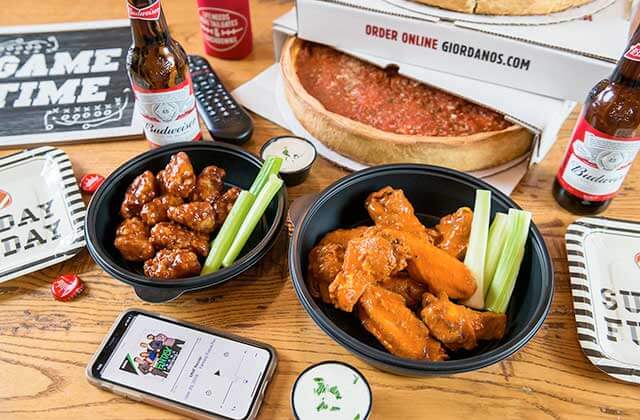 stuffed pizza in delivery box with buffalo wings beer and sides at giordanos orlando kissimmee