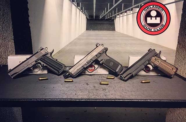 three handguns with ammo in an indoor range at orlando gun club
