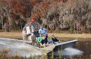 tour group riding airboat on marsh wild willys airboat tours kissimmee
