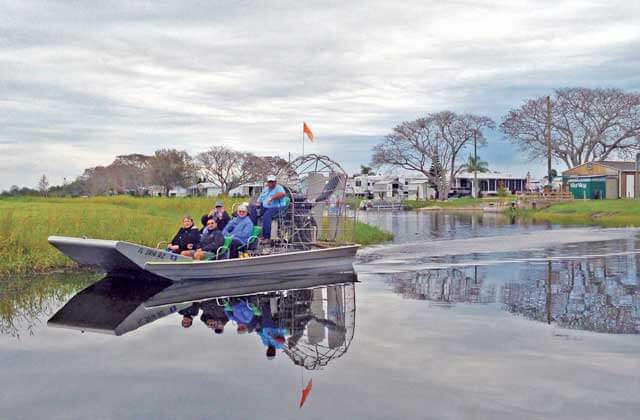 tour group riding airboat with houses wild willys airboat tours kissimmee