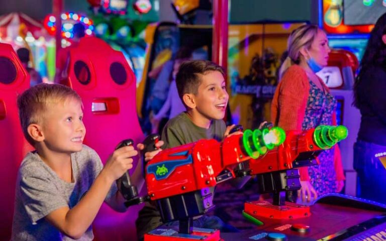 two boys competing at games in arcade at andretti indoor karting games orlando