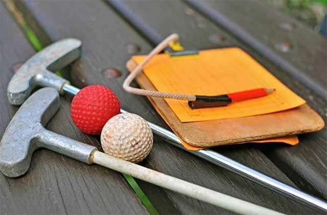 two putters with balls and score card on a bench at bonanza golf gifts kissimmee