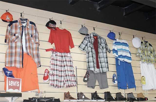 wall rack display with selection of casual mens outfits at orlandos gk menswear store