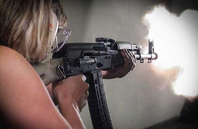 woman fires an automatic rifle in an indoor range at orlando gun club