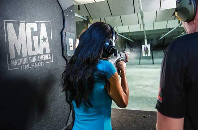 woman fires machine gun at targets at machine gun america kissimmee