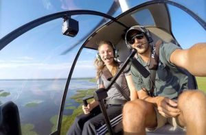young couple in cockpit with aerial view florida maxflight helicopter tour services kissimmee