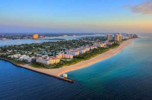 aerial view of open water inlet hotels condos jetty and sunrise at the palm beaches destination feature