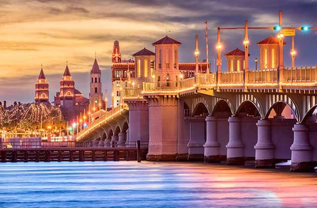 bridge of lions at twilight with skyline and streetlights at st augustine destination feature