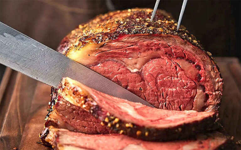 closeup of knife slicing prime rib at boston lobster feast orlando kissimmee