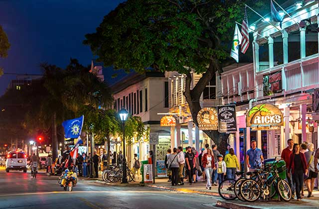 key west crowded street at night with restaurants and bars at the florida keys destination feature