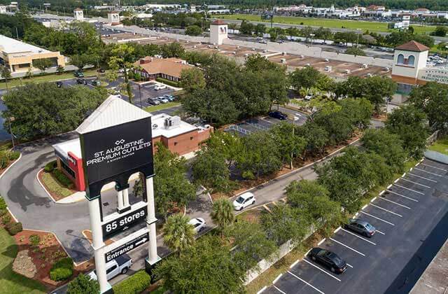 aerial shopping center with sign trees and parking at st augustine premium outlets florida