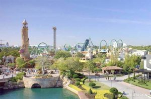 aerial view of front gate with looping rides along skyline at universals islands of adventure theme park orlando