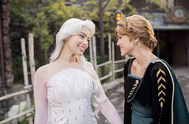 anna and elsa characters standing in the norway pavilion at disney epcot theme park orlando
