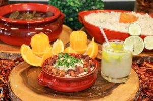 bowl of feijoada with oranges and other sides at tonys brazilian grill orlando